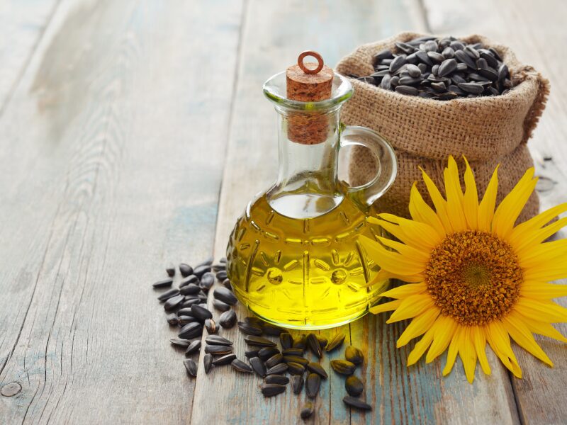 A table with sunflower seeds and oil on it