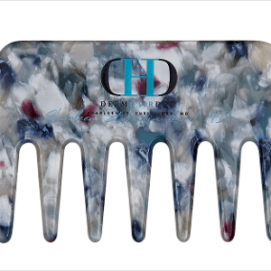 A derma hair comb with a blue, white and red design.