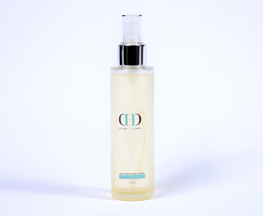 A bottle of body oil sitting on top of a table.