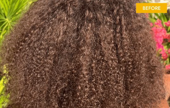 Curly hair texture before treatment, outdoors.