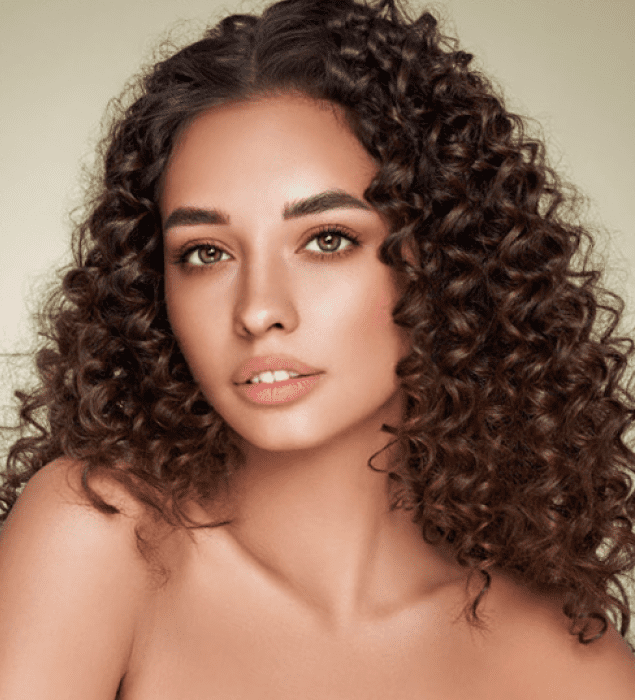 Curly-haired woman with neutral expression.