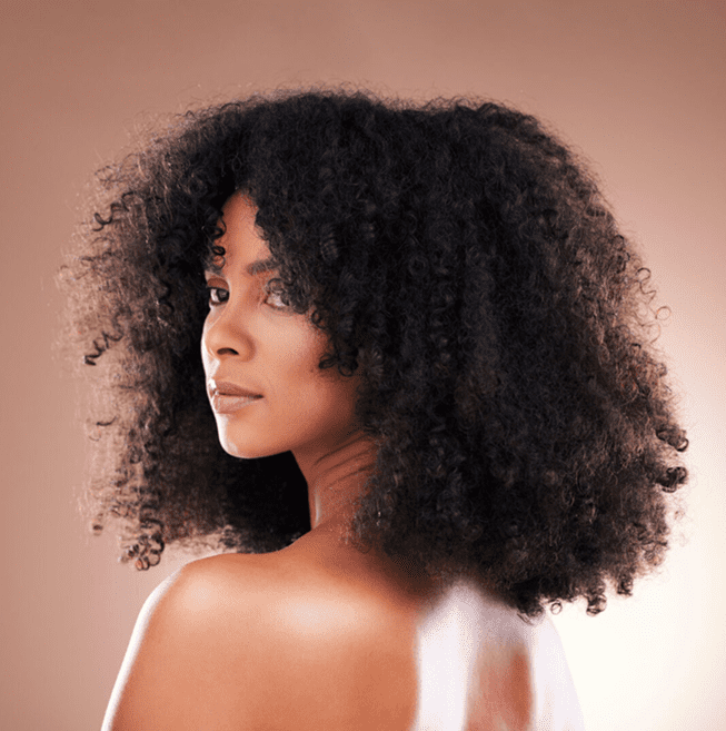 Woman with voluminous curly hairstyle.
